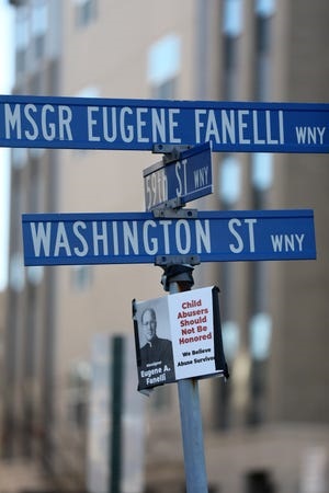 A street sign at the intersection of Washington St. and 59th St. in West New York honors Monsignor Eugene Fanelli. Another sign that was placed on the pole alleges the monsignor was a child abuser. At least four people claim they were abused by Fanelli. - Kevin R. Wexler/NorthJersey.com