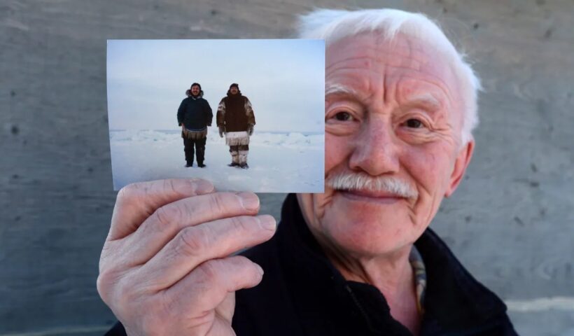 Piita Irniq holds a photograph of himself and Marius Tungilik while seal hunting 25 miles outside Rankin Inlet. Irniq promised his late friend, who named Rivoire as his abuser, he would do all he could for him and Rivoire's other alleged victims. (Sean Kilpatrick/The Canadian Press