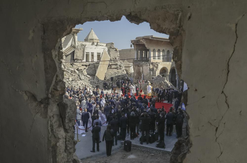 Pope Francis, surrounded by shells of destroyed churches, leads a prayer for the victims of war at Hosh al-Bieaa Church Square, in Mosul, Iraq, March 7, 2021. Pope Francis is celebrating his 85th birthday Friday, Dec. 17, 2021, a milestone made even more remarkable given the coronavirus pandemic, his summertime intestinal surgery and the weight of history: His predecessor retired at this age and the last pope to have lived any longer was Leo XIII over a century ago. (AP Photo/Andrew Medichini, file)