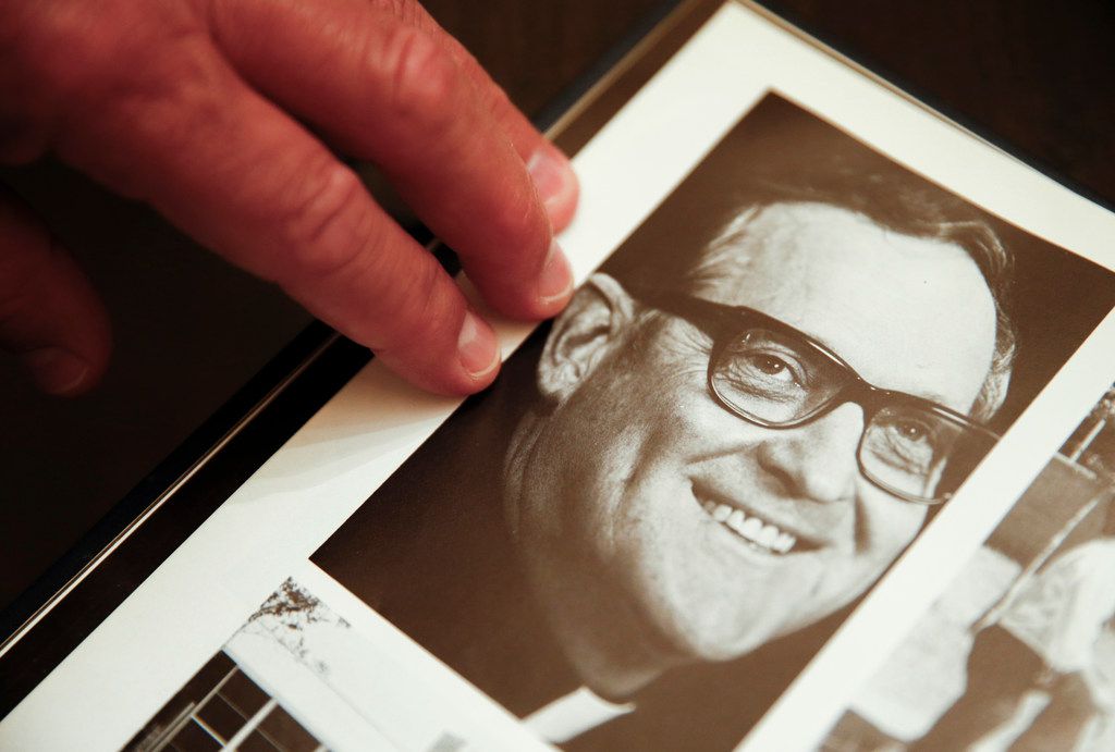 Mike Pedevilla, who also says the Rev. Patrick Koch sexually abused him while he was a student at Jesuit Dallas, points to a picture of Koch in a 1980s yearbook.(Ryan Michalesko / Staff Photographer)
