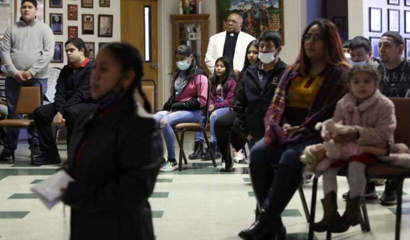 The Rev. Athanasius Abanulo stands behind a group of parishioners as they hold a special ceremony for the Lady of Guadalupe at Holy Family Catholic Church in Lanett, Ala., on Sunday, Dec. 12, 2021. Originally from Nigeria, Abanulo is one of numerous international clergy helping ease a U.S. priest shortage by serving in Catholic dioceses across the country. (AP Photo / Jessie Wardarski)