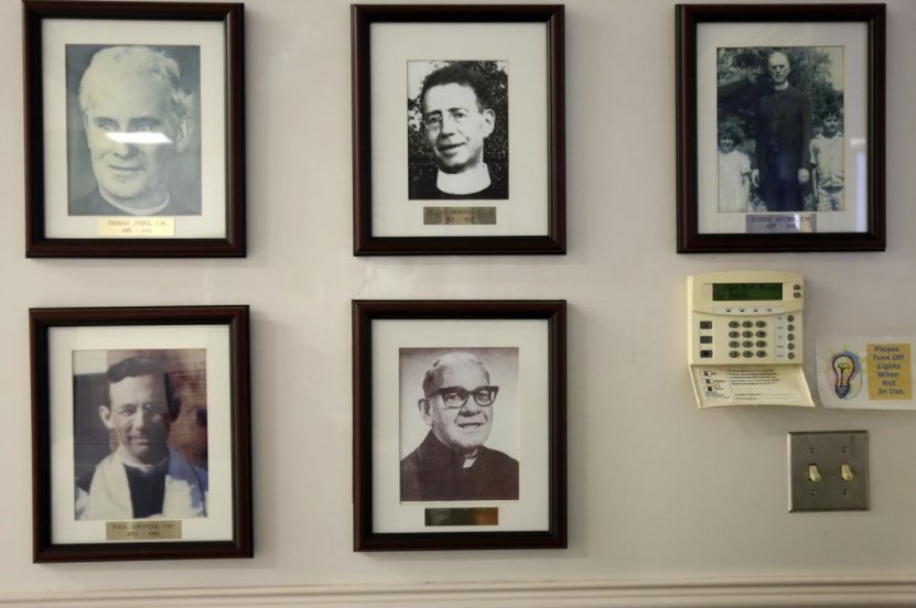 Portraits of past priests hang on the walls of Holy Family Catholic Church in Lanett, Ala., on Saturday, Dec. 11, 2021. The Catholic Diocese of Birmingham and dioceses across the country continue to experience a large priest shortage. (AP Photo / Jessie Wardarski)