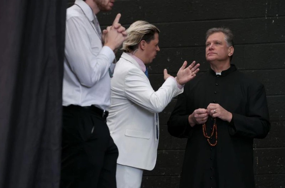 British far-right political pundit Milo Yiannopoulos, center, talks with the Rev. Paul Kalchik backstage during the "Bishops Enough Is Enough" rally at the MECU Pavilion in Baltimore on Nov. 16, 2021. Organized to coincide and run counter to the U.S. Conference of Catholic Bishops at the nearby Marriott Baltimore Waterfront, the conservative prayer meeting and convention was organized by the far-right Catholic news outlet St. Michael's Media, also known as Church Militant. (Chip Somodevilla / Getty Images)
