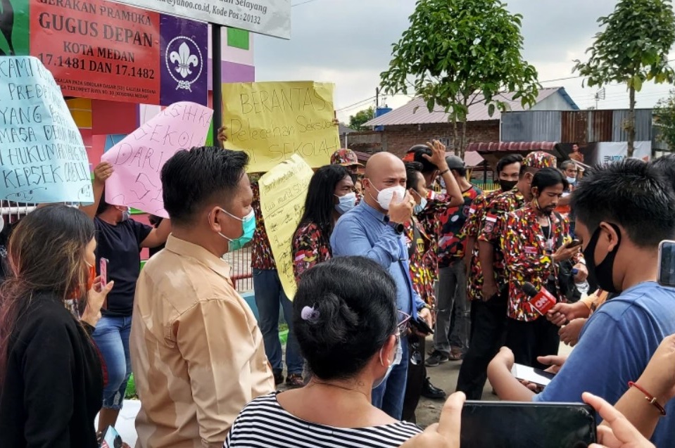 A group of parents hold a protest outside the Galilea Hosana School in Medan after a priest was accused of sexually assaulting some of the young girls attending the institution [Aisyah Llewellyn / Al Jazeera]