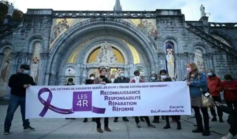 Members of the 'From words to action' collective hold a banner reading 'Victims of sexual violence in the Catholic Church demand: recognition, responsibility, reparation, reform' near the Notre-Dame-du-Rosaire basilica, in Lourdes, France Photograph:( AFP )