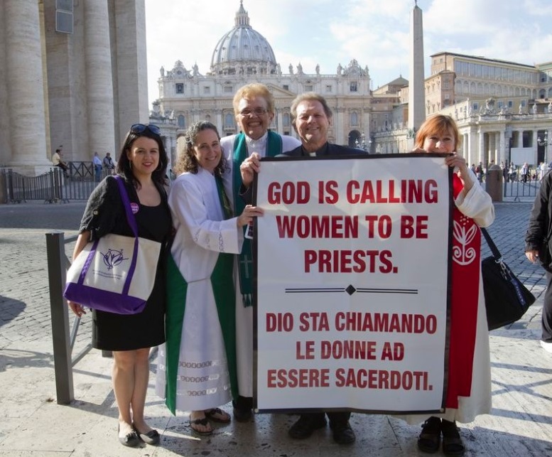 From right, Janice Sevre, Reverend Roy Bourgeois, Ree Hudson, Donna Rougeux and Erin Saizhanna, members of the Women's Ordination Conference group, stage a protest in front of St. Peter's basilica in Rome on Monday, Oct. 17, 2011. (AP Photo / Andrew Medichini)