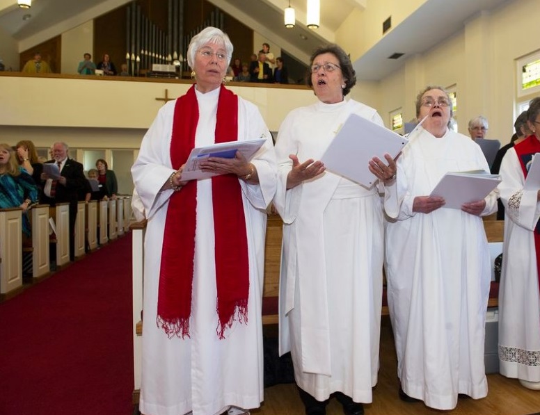 The Rev. Mary Teresa Streck, of Albany, New York, left, Irene Scaramazza, of Columbus, Ohio, center, and Susan Guzik of Eastlake, Ohio, right, sing at the beginning of the Association of Catholic Women Priests, Ordination service at Brecksville United Church of Christ in Brecksville, Ohio, Saturday, May 24, 2014. Scaramazza is one of four women ordained as priests, Guzik is one of two ordained as a deacon. (AP Photo / Phil Long)