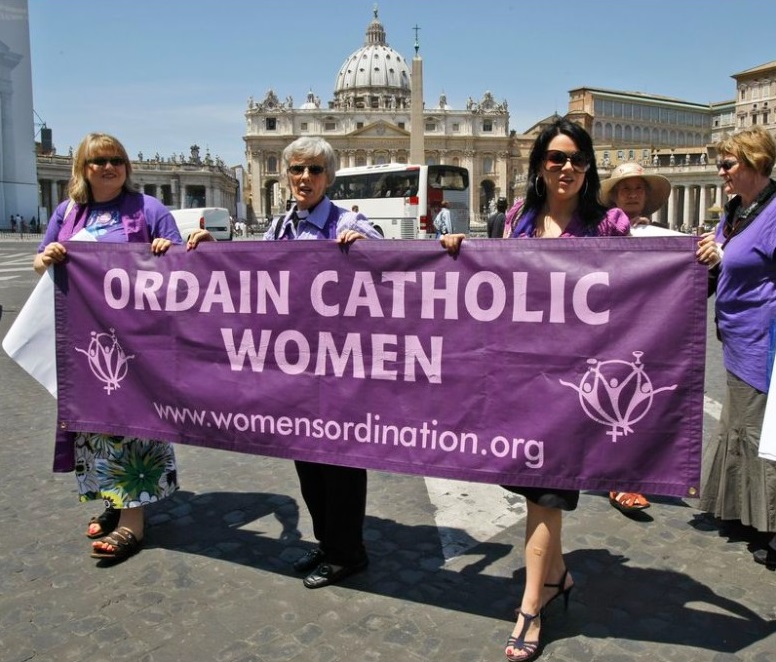 Representatives of the Women's Ordination Conference stage a protest in front of St.Peter's Basilica, in Rome, with from left, Therese Koturbash from Dauphin, Matitoba, Canada, Mary Ann Schoettly from Newton, N.J, US, and Erin Saiz Hanna, Washington, D.C. US, as they protest on Tuesday, June 8, 2010. Groups that have long demanded that women be ordained Roman Catholic priests took advantage of the Vatican's crisis over clerical sex abuse to press their cause demanding the Vatican open discussions on letting women join the priesthood. (AP Photo / Pier Paolo Cito)