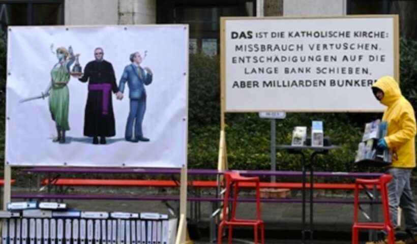 A board reads 'That's the Catholic Church: covering up abuse, putting off reparations but stashing away billions' to protest a recent report on child sex abuse in the Archdiocese of Munich-Freising in Germany. (Photo: AFP)
