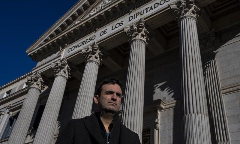 Miguel Hurtado, who has campaigned against impunity since disclosing his own account of being abused at a monastery in northeastern Spain, poses for a picture in front of a Spanish parliament in Madrid, Spain, Tuesday, Feb. 1, 2022. After decades of neglect, victims of sexual abuse by the Spanish clergy say that they are finally seeing momentum building towards their quest for real accountability and reparations. On Tuesday, Spanish lawmakers took the first step towards opening a parliamentary inquiry on the issue, a move that victims hail as a potential game-changer. Prosecutors are also stepping up efforts to dig deeper into existing and new allegations. (AP Photo/Manu Fernandez)