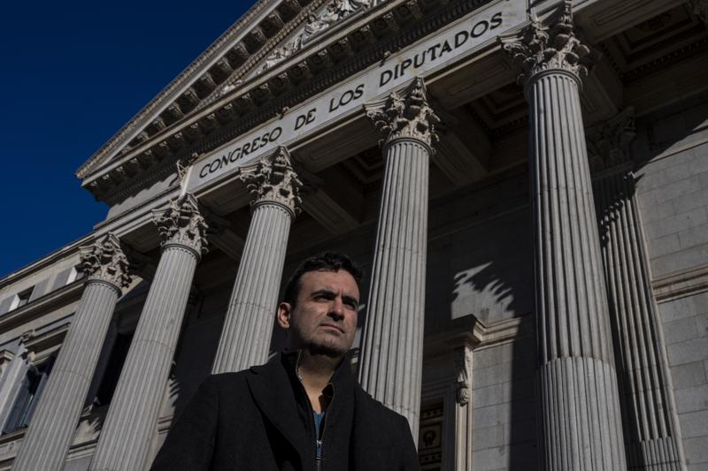 Miguel Hurtado, who has campaigned against impunity since disclosing his own account of being abused at a monastery in northeastern Spain, poses for a picture in front of a Spanish parliament in Madrid, Spain, Tuesday, Feb. 1, 2022. After decades of neglect, victims of sexual abuse by the Spanish clergy say that they are finally seeing momentum building towards their quest for real accountability and reparations. On Tuesday, Spanish lawmakers took the first step towards opening a parliamentary inquiry on the issue, a move that victims hail as a potential game-changer. Prosecutors are also stepping up efforts to dig deeper into existing and new allegations. (AP Photo/Manu Fernandez)