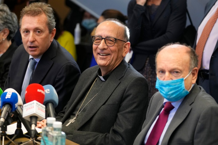 The President of the Spanish Episcopal Conference, Cardinal Juan Jose Omella, centre, reacts to a question next to Spanish lawyer Javier Cremades, left, during a press conference in Madrid, Spain, Tuesday, Feb. 22, 2022. Spanish bishops are tasking a private law firm with a year-long inquiry into past and present sexual abuse committed by members and associates of the Catholic Church. The move is a departure from years rejecting comprehensive action but some sex abuse survivors still regard it as insufficient. (Credit: Paul White/AP.)