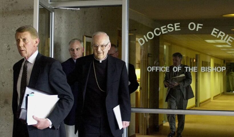 Erie County District Attorney Brad Foulk, left, and Erie Catholic Bishop Donald W. Trautman, right, walk out of an office at the Erie diocese's headquarters on April 15, 2002, after the two met over clergy abuse cases as the clergy abuse crisis was exploding nationwide. Foulk died in 2009. File Photo, Erie Times-News