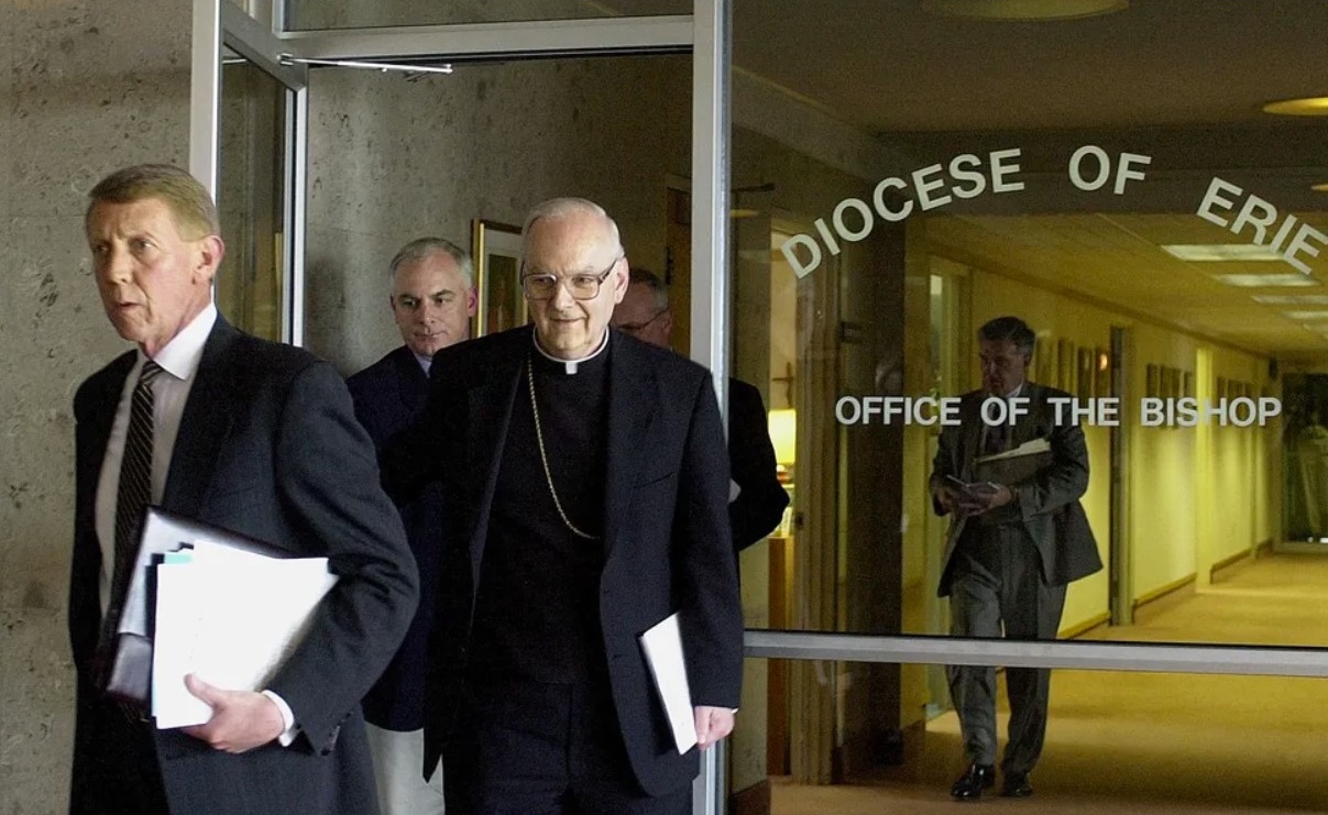 Erie County District Attorney Brad Foulk, left, and Erie Catholic Bishop Donald W. Trautman, right, walk out of an office at the Erie diocese's headquarters on April 15, 2002, after the two met over clergy abuse cases as the clergy abuse crisis was exploding nationwide. Foulk died in 2009. File Photo, Erie Times-News