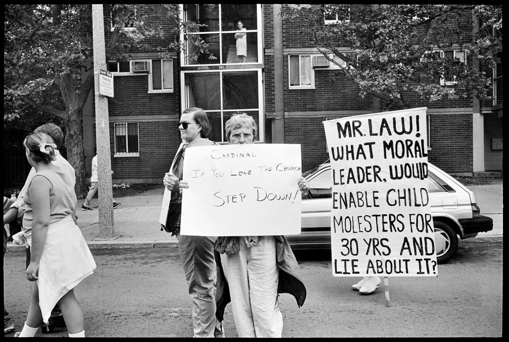 Lisa Kessler, "What Moral Leader" (2002). Catholics of all stripes walk through Boston to show support for victims of clergy abuse. Hundreds gathered at the steps of the Cathedral of the Holy Cross, Cardinal Bernard Law's home church, where many victims told their stories of abuse to a sympathetic crowd. Boston, June 2002. ©LISA KESSLER, COURTESY HOWARD YEZERSKI GALLERY