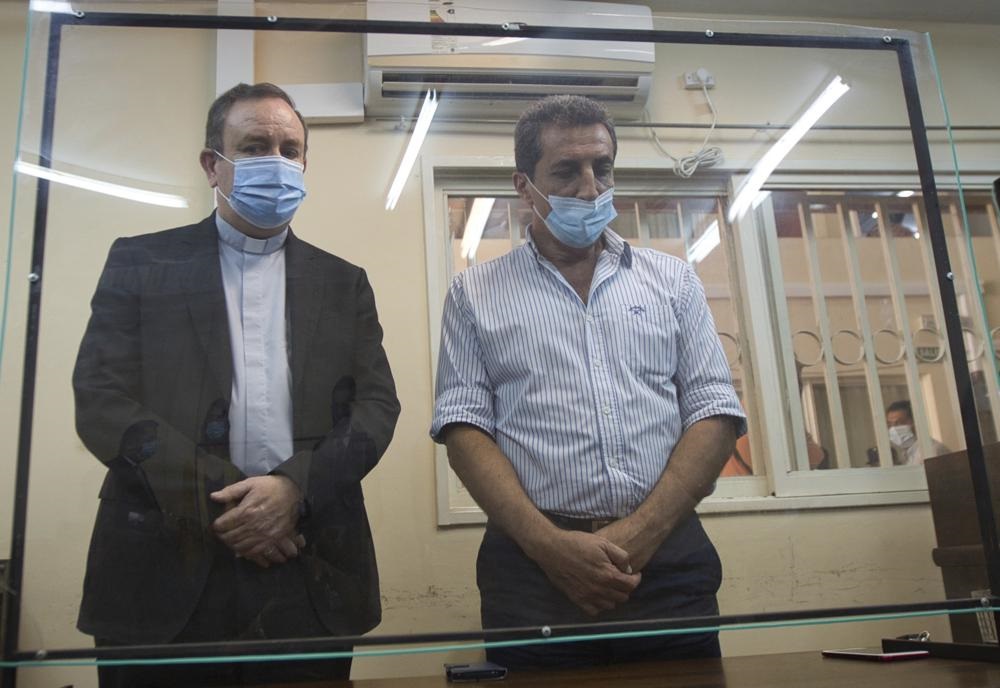 Argentine Bishop Gustavo Zanchetta, left, stands with his lawyer Enzo Gianotti after he was convicted and sentenced to 4 1/2 years in prison for continued sexual abuse of two former seminarians in Oran, Argentina, Friday, March 4, 2022. (AP Photo/Javier Corbalan)