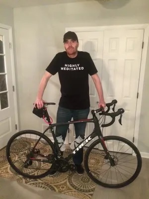 David Ohlmuller, who was abused as a boy by a Catholic priest in Montclair, New Jersey, poses with his bicycle in his home near Chicago before setting out on a bicycle ride from Chicago to New Jersey to draw attention to the Catholic sex abuse crisis.  His journey is depicted in the documentary film, Peloton of One.