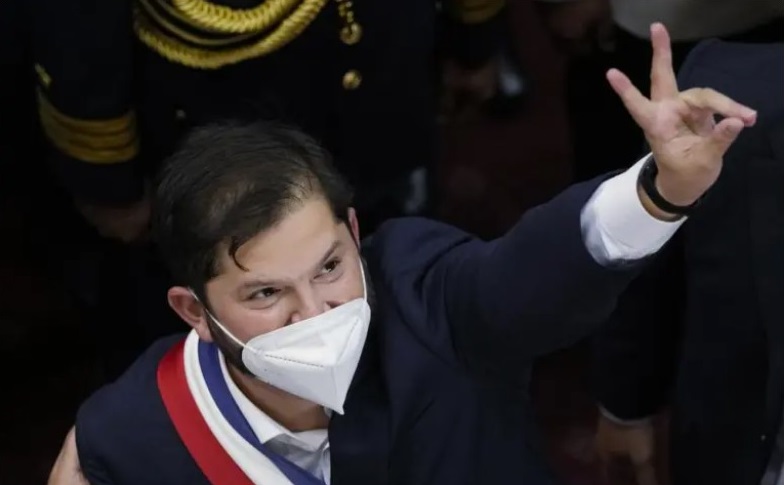 Chile’s new President Gabriel Boric flashes a victory sign after his swearing-in ceremony at Congress in Valparaiso, Chile, Friday, March 11, 2022. (Credit: AP Photo / Esteban Felix.)