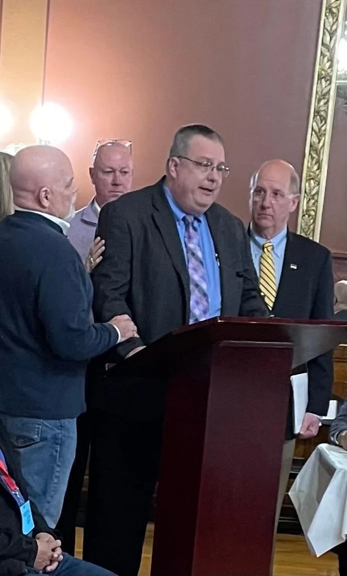 Dennis Laprade, who says his claims of childhood abuse by a Catholic priest went nowhere because of the statute of limitations, breaks down while testifying before the Rhode Island House Judiciary Committee on Thursday night. Standing to support him are, from left, Pasco Troia, Jim Scanlan and Herbert "Hub" Brennan, all victims of childhood sexual abuse.