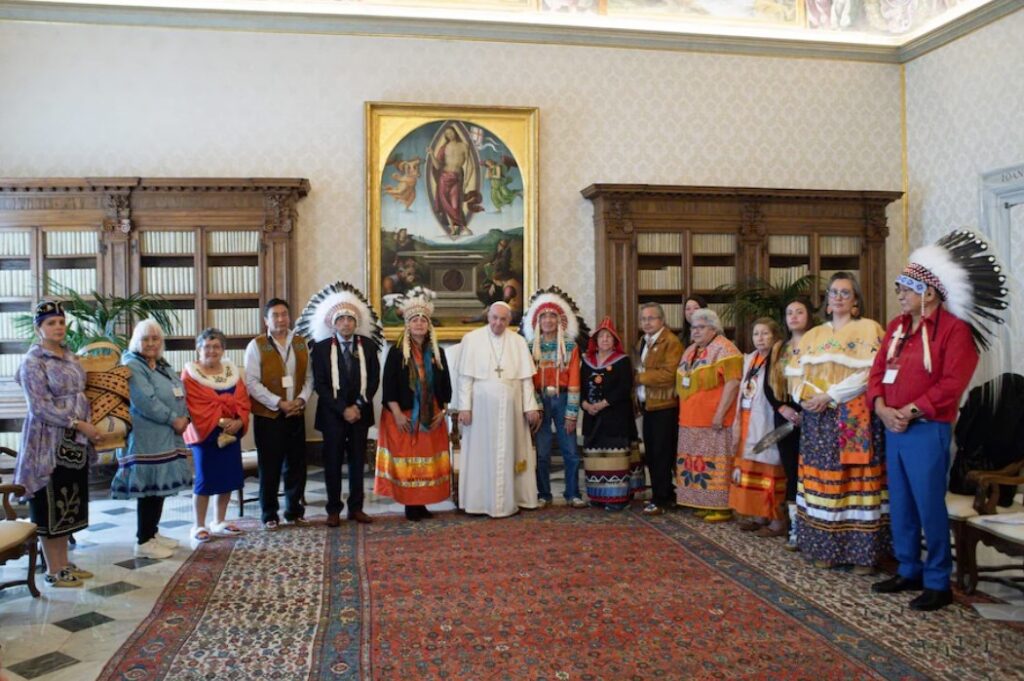 This photo taken on March 31, 2022 shows Pope Francis posing with First Nations delegation members in The Vatican, as part of a series of meetings of Indigenous elders, leaders, survivors and youth at the Vatican. (Handout / AFP / Getty Images)