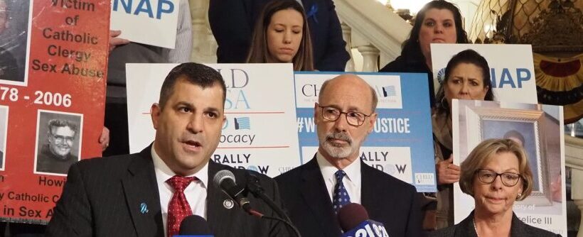 Rep. Mark Rozzi (D-Berks), left, speaks during an April 4, 2022 rally in Harrisburg on a bill that would open a new legal time window for survivors of child sexual abuse.