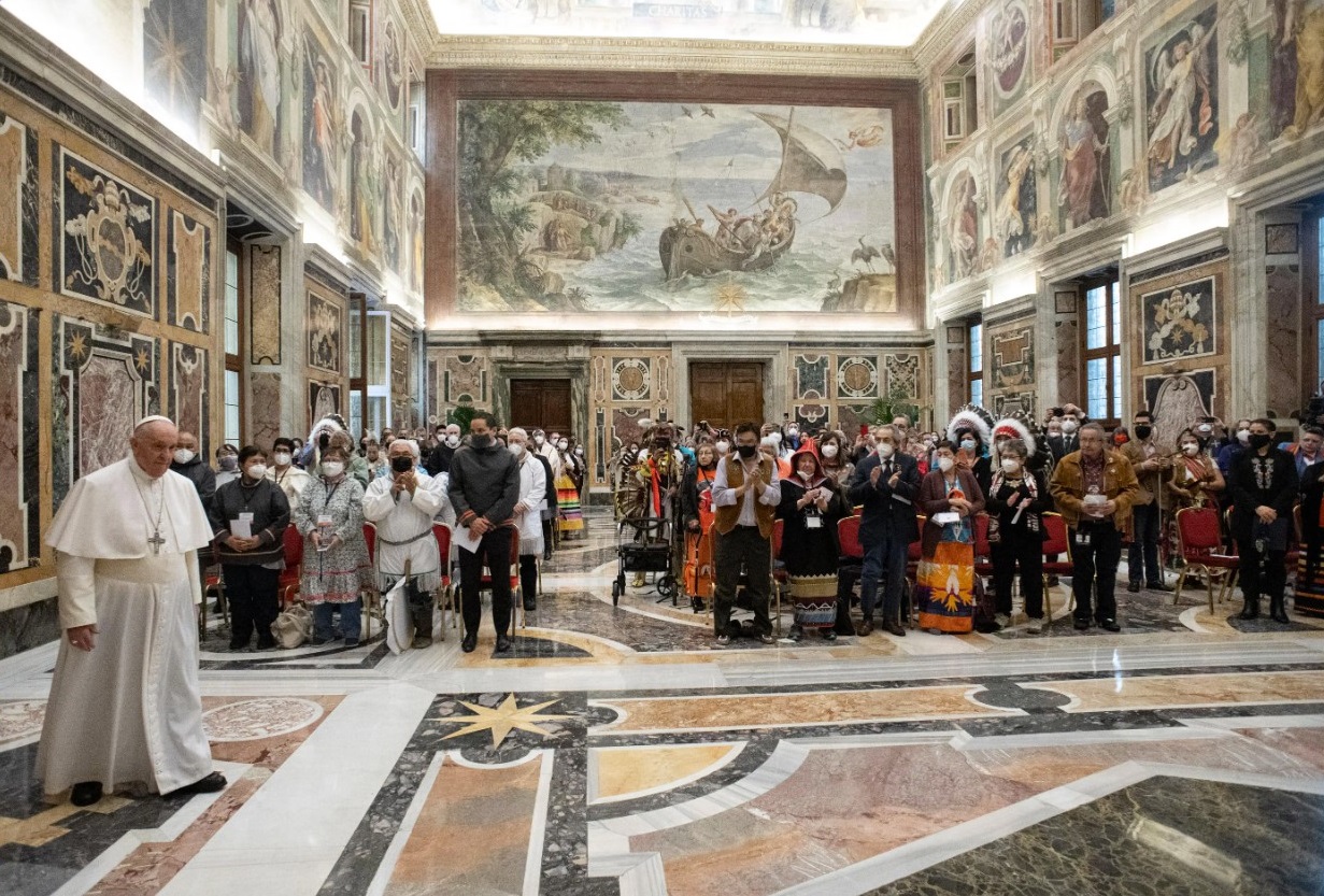 Indigenous delegates stand with Pope Francis after the Pontiff delivered an apology for the Catholic Church’s role in Canada's residential school system at the Vatican on April 1, 2022. HO-Vatican Media / The Canadian Press