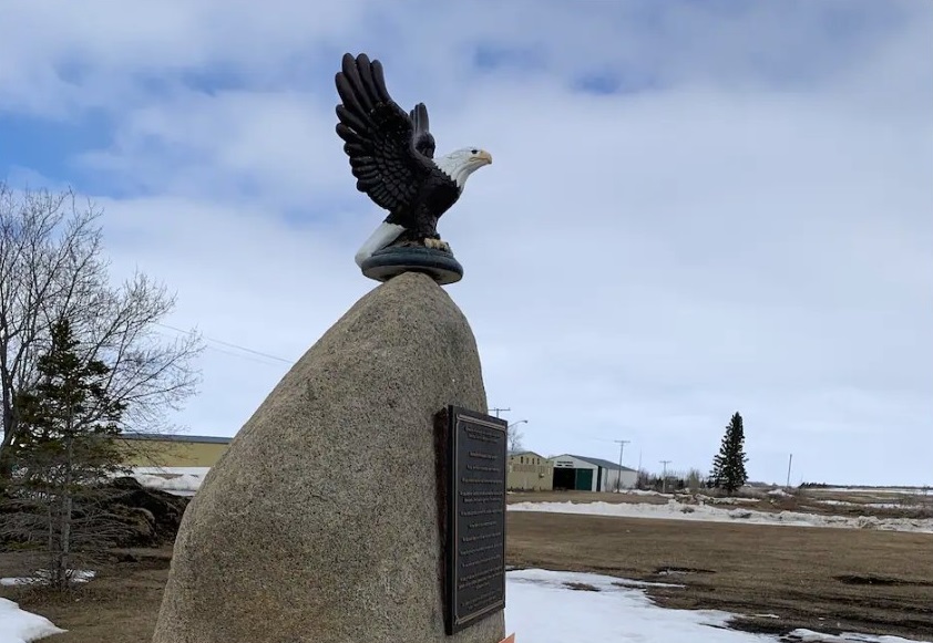A sculpture of an eagle with wings outstretched stands atop a memorial to residential school students in Keeseekoose First Nation in Saskatchewan. Ted Quewezance