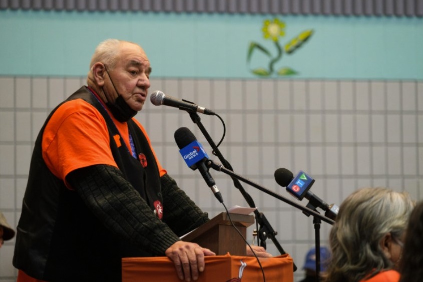 Ted Quewezance announces the discovery of 54 unmarked graves during a public event at the Keeseekoose School Gymnasium at Keeseekoose First Nation on Tuesday Feb. 15, 2022. Michael Bell / The Canadian Press