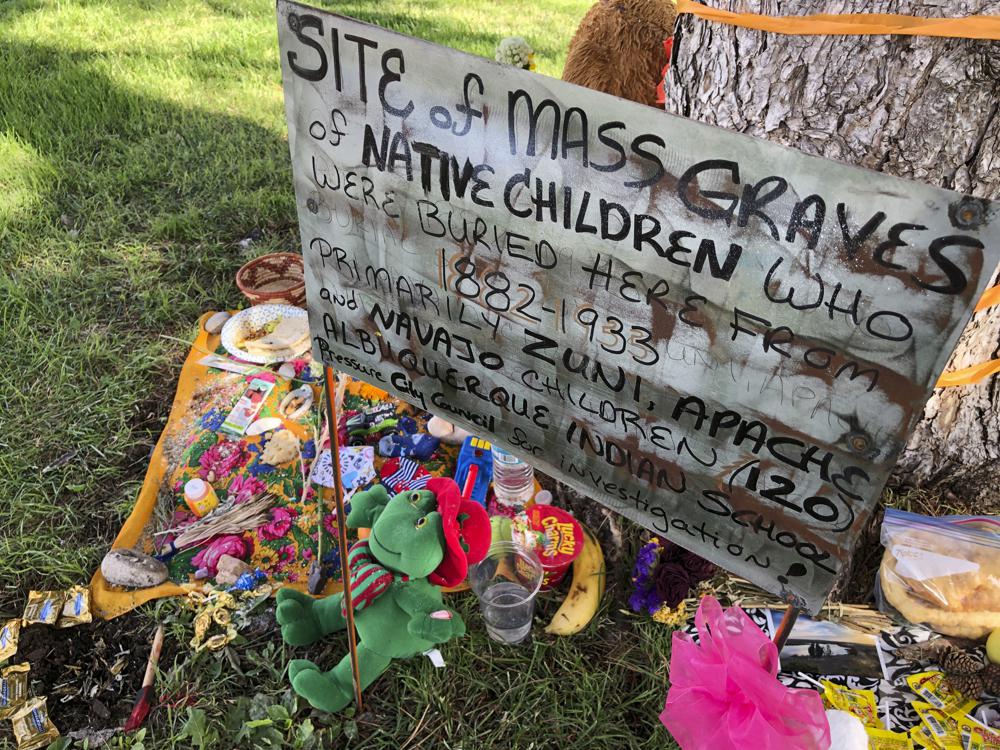 FILE - In this July 1, 2021, file photo, a makeshift memorial for the dozens of Indigenous children who died more than a century ago while attending a boarding school that was once located nearby is growing under a tree at a public park in Albuquerque, N.M. A new federal report on the legacy of boarding schools for Native Americans underscores how closely the U.S. government collaborated with churches to Christianize the Indigenous population as part of a project to sever them from their culture, their identities and ultimately their land. The Department of the Interior report, released Wednesday, May 11, 2022, says the federal government provided funding and other support to religious boarding schools for Native children in the 19th and early 20th centuries to an extent that normally would have been prohibited by bans on the use of federal funds for religious schools. (AP Photo/Susan Montoya Bryan, File)
