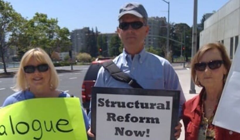 Tim Stier with fellow activists. Full text of the signs: Left: Dialogue, Transparency, and Inclusion Now! Right: Structural Reform Now! Include the Excluded: Women, Gay Persons, Abuse Survivors. Source: https://timstier.weebly.com/about.html
