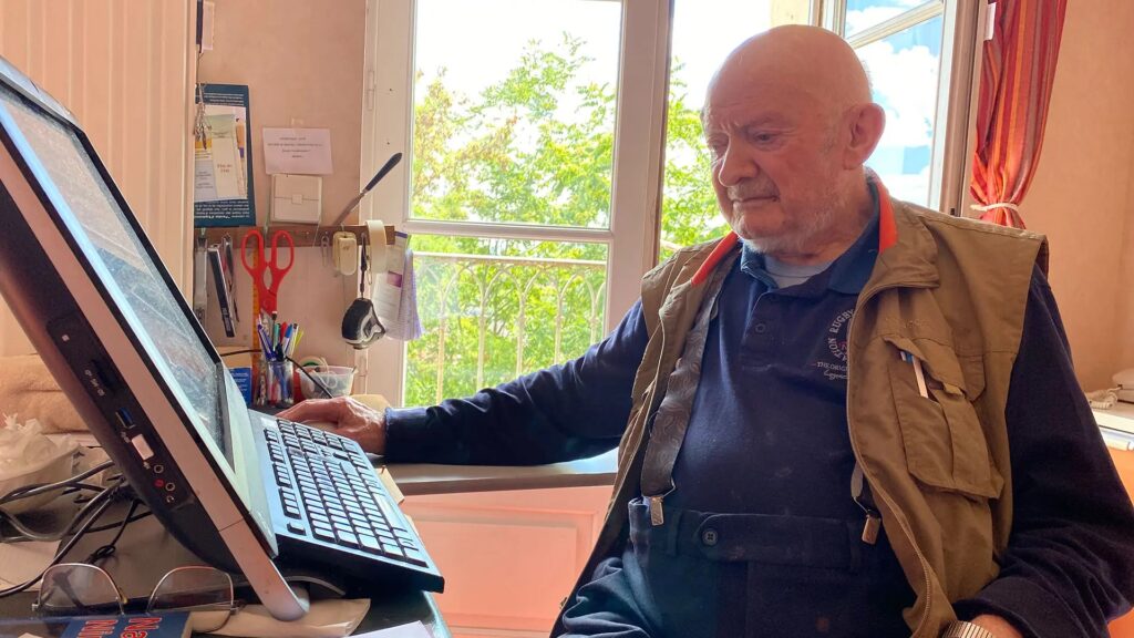 Oblate priest Joannes Rivoire at his computer. Photo: Agustin Lucardi for APTN News