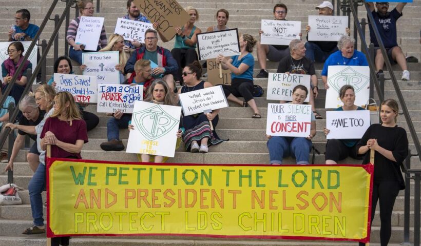 Protesters gather on the steps of the Utah State Capitol, at a rally to gain support for removing the clergy exemption from mandatory reporting in cases of abuse and neglect, on Friday, Aug. 19, 2022 in Salt Lake City. Demonstrators gathered outside the Utah Capitol on Friday to demand lawmakers remove an exemption from state law that frees religious leaders from being required to report sexual abuse when perpetrators mention it in confessions. (Rick Egan/The Salt Lake Tribune via AP)