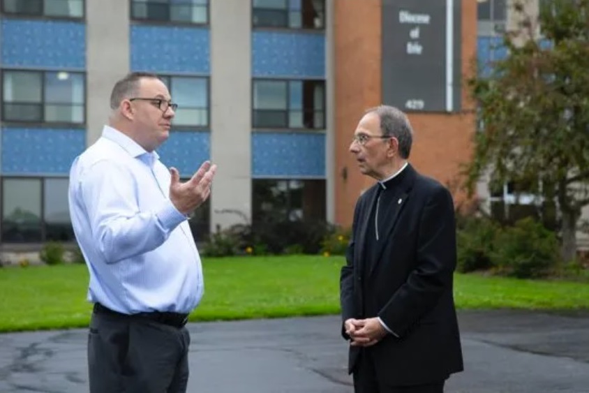 Bishop Lawrence T. Persico of Erie, Pa., speaks with Jim VanSickle of Pittsburgh, who told a Pennsylvania grand jury he was molested by a priest when he was a teenager in Bradford, Pa. VanSickle and the bishop spoke during an Aug. 21, 2018, news conference held in front of the Diocese of Erie’s headquarters by members of the Survivors Network of those Abused by Priests, or SNAP. CNS photo / Chaz Muth