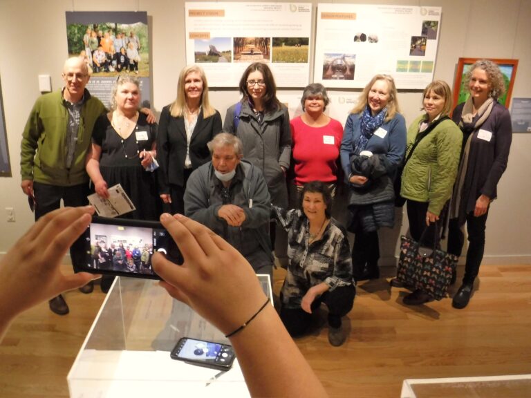 Journalist Christine Kenneally (back row center, with glasses) meets former orphanage residents and their supporters last April at the Vermont Historical Society exhibit “Voices of St. Joseph’s Orphanage.” Photo by Kevin O’Connor / VTDigger