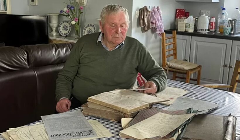 Survivor Tom Wall with his archive of documents from the Glin Industrial School.