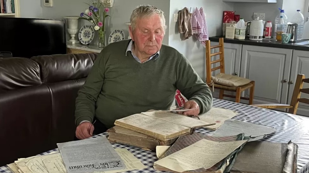 Survivor Tom Wall with his archive of documents from the Glin Industrial School.