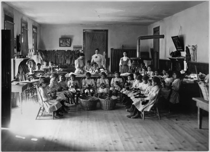 Young school girls attending a sewing class at the Albuquerque Indian School around 1910. National Archives, Denver, Colorado, Identifier 292877