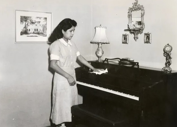 A Sherman Institute student working as a housekeeper. Sherman Institute