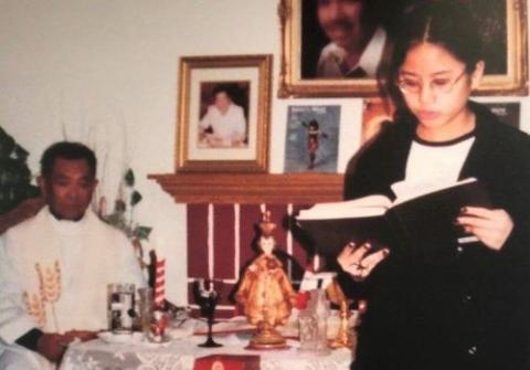 Aimee Torres, pictured in 1999, reads during a Mass celebrated by Fr. Honesto Bayranta Bismonte in her family's home. In 2002, Bismonte was arrested and charged with sexually molesting two young girls, including Torres. He pleaded guilty to misdemeanor battery and was sentenced to two years of informal probation in Los Angeles and was removed from active ministry. (Courtesy of Aimee Torres)