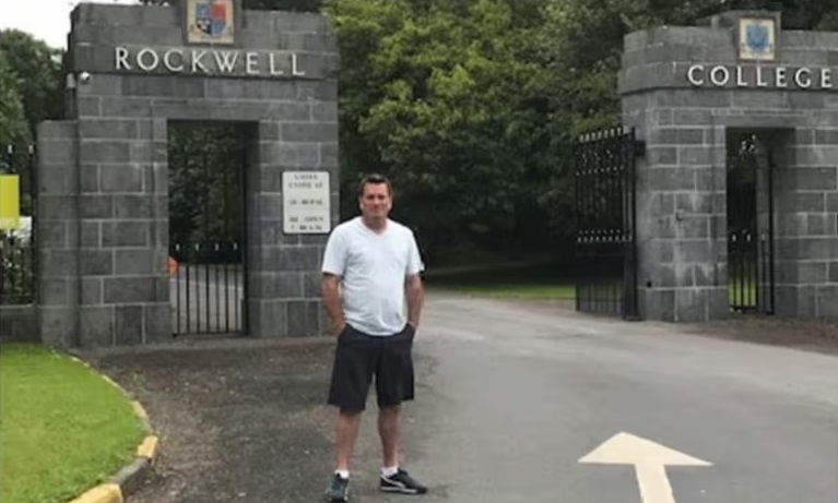Derek McCarthy of Pennsylvania stands outside the Irish boarding school where he says he was sexually abused repeatedly as a student in the 1970s. Photograph: Courtesy of Derek McCarthy