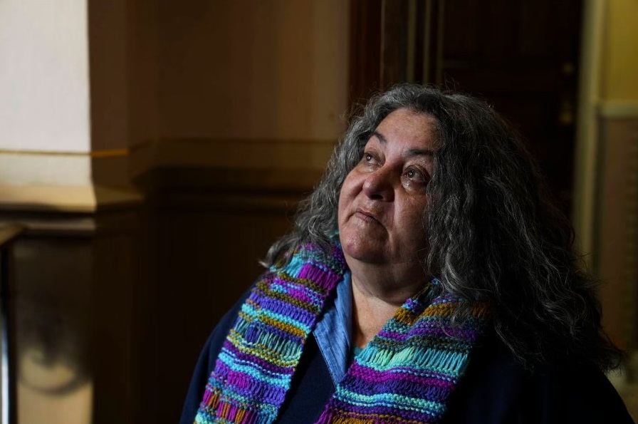 Linda Malat Tiburzi says a prayer and lights candles in honor of a friend and former classmate, Eddie Blair, who died before the trial of their former teacher in January 2023. Tiburzi, who dedicated her life to supporting abuse survivors, died Tuesday, Oct. 17, 2023, at age 62. (Kaitlin Newman / The Baltimore Banner)