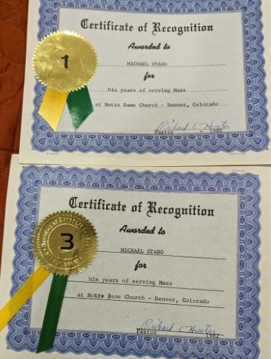 Two certificates [for years of serving Mass at Notre Dame Church in Denver, Colorado] presented to Michael Stano by Monsignor Richard Hiester [in 1980 and 1982]. Credit: Courtesy of Michael Stano