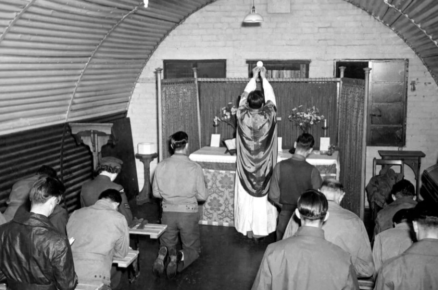The Rev. Edmund Skoner, a Catholic priest recently placed on the Archdiocese of Chicago’s list of credibly accused clergy, celebrates mass with troops during World War II, during which time he served as a U.S. military chaplain. American Air Museum in Britain
