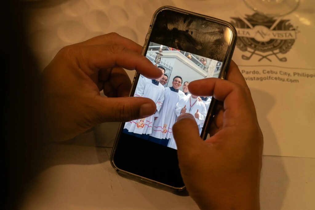 Mr. Gatchalian showing a photo of himself in his cassock. He was an altar boy at the Basílica Minore del Santo Niño de Cebu, which was founded in the 1500s.(Photographs by Jes Aznar)