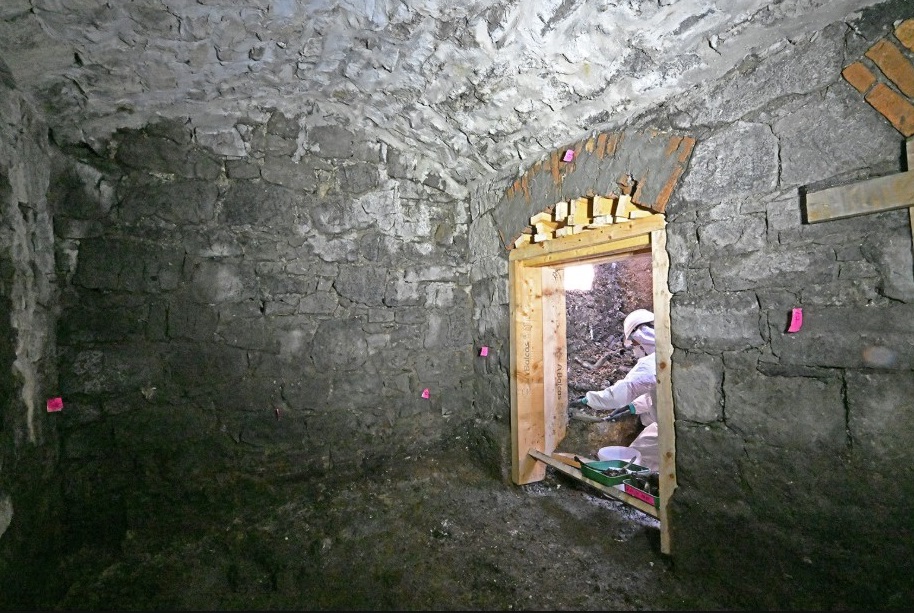 A forensic excavation team member working inside the subterranean vaulted structure. Credit Office of the Director of Authorized Intervention at Tuam (ODAIT).